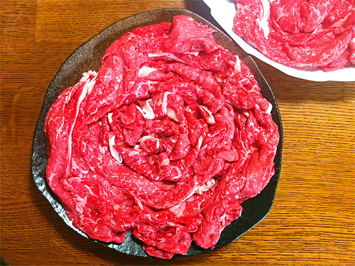 赤色の牛薄切り肉が器に乗っている写真